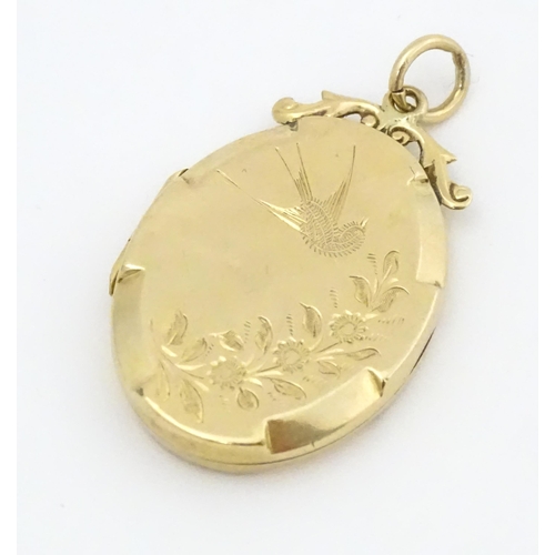 643 - A 9ct gold back & front locket of oval form with engraved swallow and forget-me-knot detail. Approx.... 