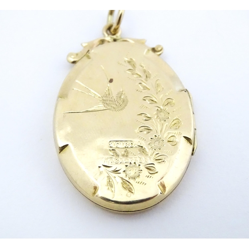 643 - A 9ct gold back & front locket of oval form with engraved swallow and forget-me-knot detail. Approx.... 