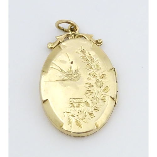 643 - A 9ct gold back & front locket of oval form with engraved swallow and forget-me-knot detail. Approx.... 