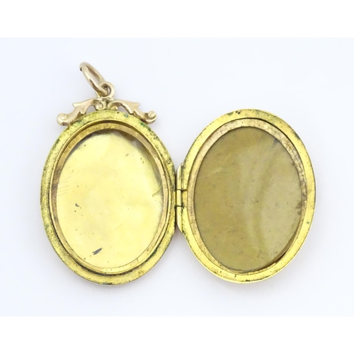 643 - A 9ct gold back & front locket of oval form with engraved swallow and forget-me-knot detail. Approx.... 