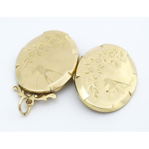 643 - A 9ct gold back & front locket of oval form with engraved swallow and forget-me-knot detail. Approx.... 