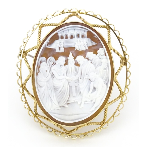 648 - A shell carved cameo brooch depicting The Marriage of the Virgin after Raphael within a 9ct gold mou... 