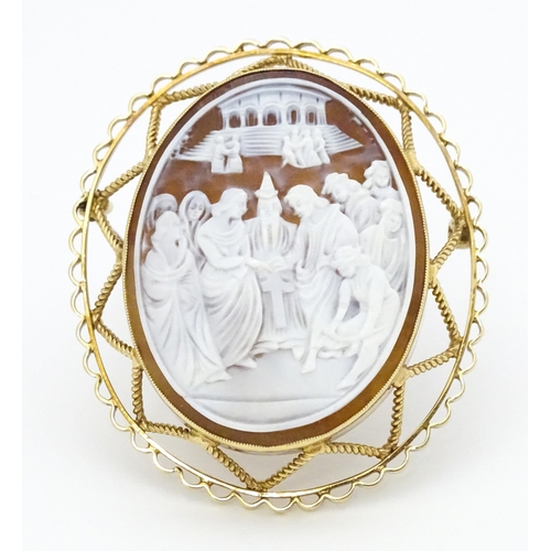 648 - A shell carved cameo brooch depicting The Marriage of the Virgin after Raphael within a 9ct gold mou... 