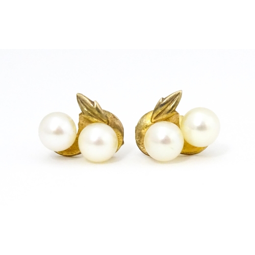 658 - A pair of 9ct gold stud earrings with double pearl detail. Approx. 1/2