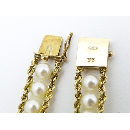 666 - A 14ct gold bracelet set with band of pearls. Approx. 7