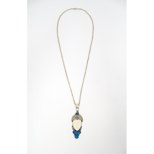 687 - A silver and white metal pendant and chain, the pendant formed as the head of a stylised flapper dan... 