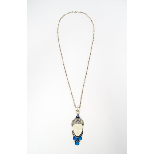 687 - A silver and white metal pendant and chain, the pendant formed as the head of a stylised flapper dan... 