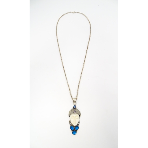 687 - A silver and white metal pendant and chain, the pendant formed as the head of a stylised flapper dan... 