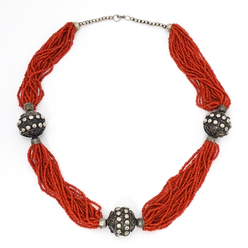 726 - A coral necklace of 23 strands with bead spacers. Approx. 26