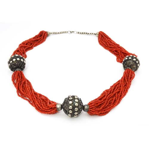 726 - A coral necklace of 23 strands with bead spacers. Approx. 26