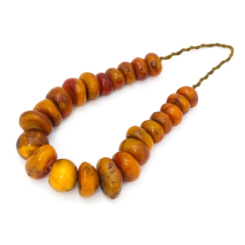 727 - A necklace of graduated amber coloured beads. Smallest approx. 1 1/4