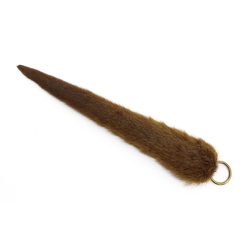 1287 - Taxidermy: an early 20thC mounted Otter's rudder, with brass hanging loop, approx 19