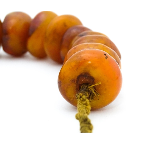 727 - A necklace of graduated amber coloured beads. Smallest approx. 1 1/4