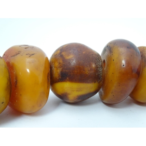 727 - A necklace of graduated amber coloured beads. Smallest approx. 1 1/4