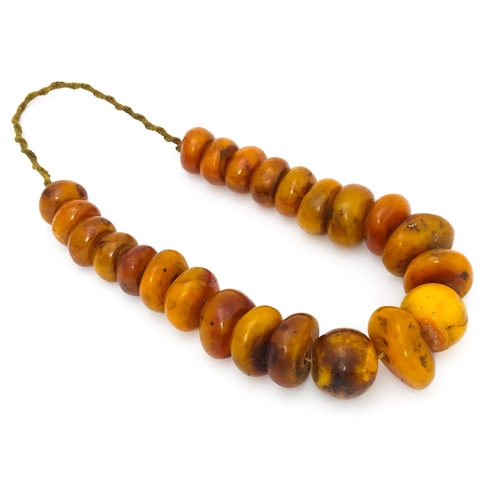 727 - A necklace of graduated amber coloured beads. Smallest approx. 1 1/4