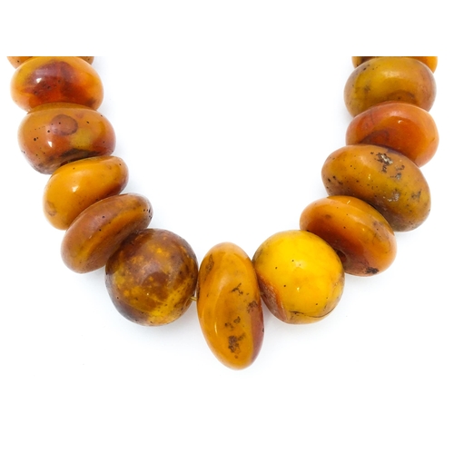 727 - A necklace of graduated amber coloured beads. Smallest approx. 1 1/4