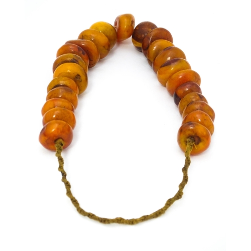 727 - A necklace of graduated amber coloured beads. Smallest approx. 1 1/4