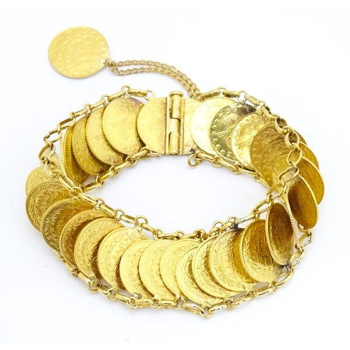 765 - A gold bracelet set with approximately 28 Ottoman coins. Approx. 7