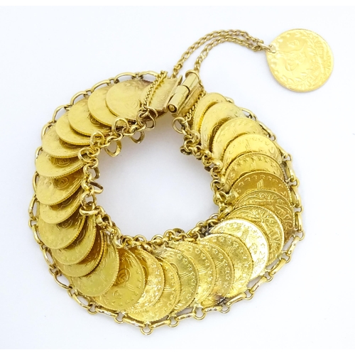 765 - A gold bracelet set with approximately 28 Ottoman coins. Approx. 7