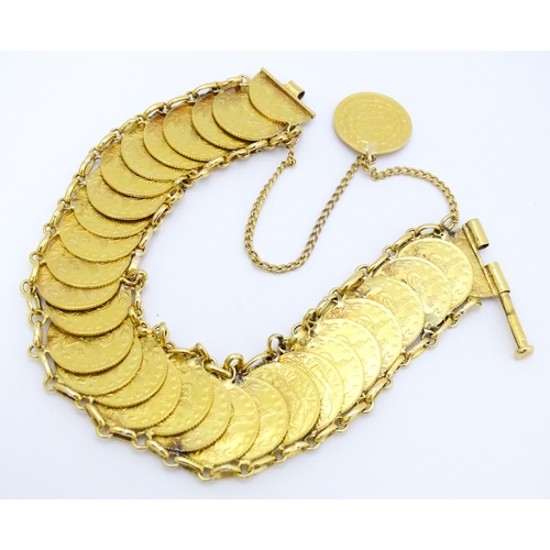 765 - A gold bracelet set with approximately 28 Ottoman coins. Approx. 7