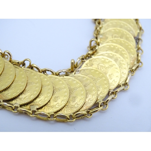 765 - A gold bracelet set with approximately 28 Ottoman coins. Approx. 7