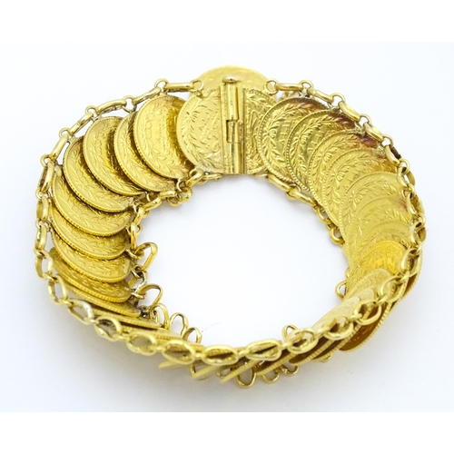 765 - A gold bracelet set with approximately 28 Ottoman coins. Approx. 7