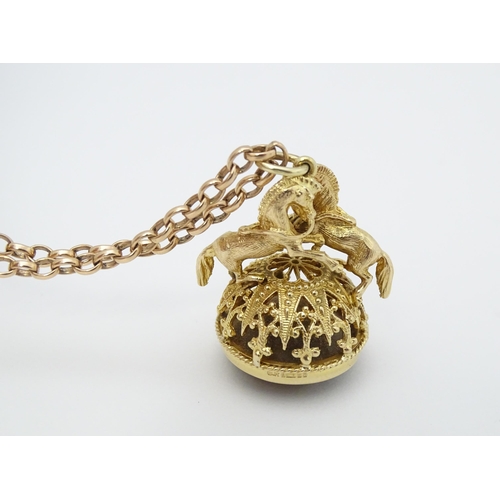 769 - A 9ct gold pendant fob seal surmounted by a pair of prancing horses / ponies and set with facet cut ... 