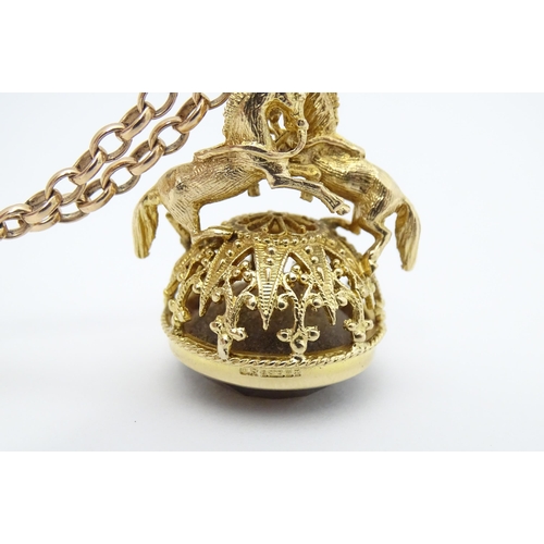 769 - A 9ct gold pendant fob seal surmounted by a pair of prancing horses / ponies and set with facet cut ... 