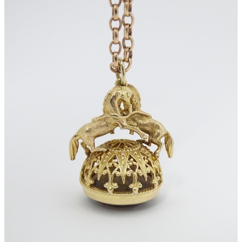 769 - A 9ct gold pendant fob seal surmounted by a pair of prancing horses / ponies and set with facet cut ... 