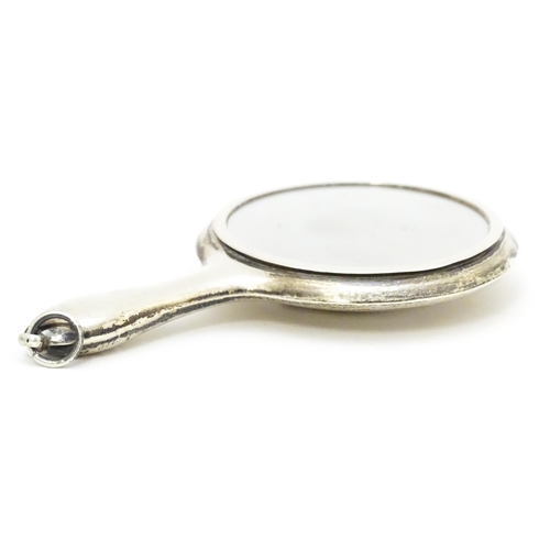 385 - A small silver hand mirror with compact section to back. Approx 4 1/4