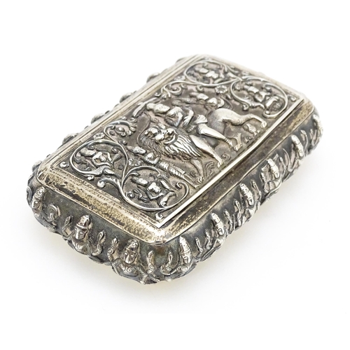 522 - A white metal snuff box decorated with various deities, including one to centre depicting a deity ri... 