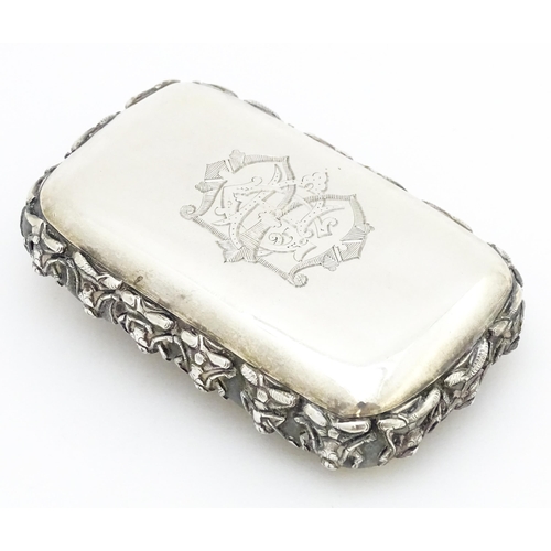 522 - A white metal snuff box decorated with various deities, including one to centre depicting a deity ri... 