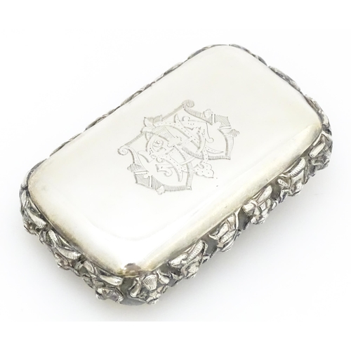 522 - A white metal snuff box decorated with various deities, including one to centre depicting a deity ri... 