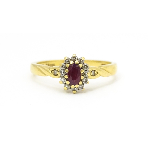 568 - An 18ct gold ring set with central ruby bordered by diamonds. Ring size approx. M 1/2.