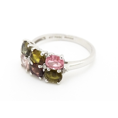 575 - A 9ct white gold ring set with diamonds and various coloured stones. Ring size approx. L