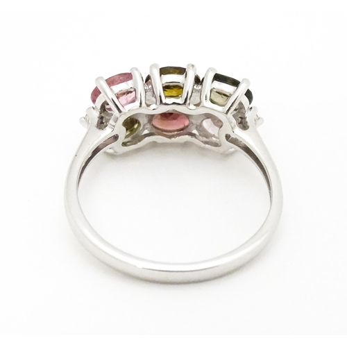 575 - A 9ct white gold ring set with diamonds and various coloured stones. Ring size approx. L