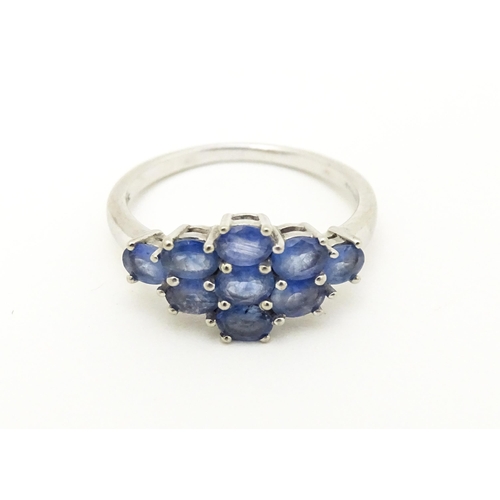 594 - A 9ct white gold ring set with blue stones. Ring size approx. N