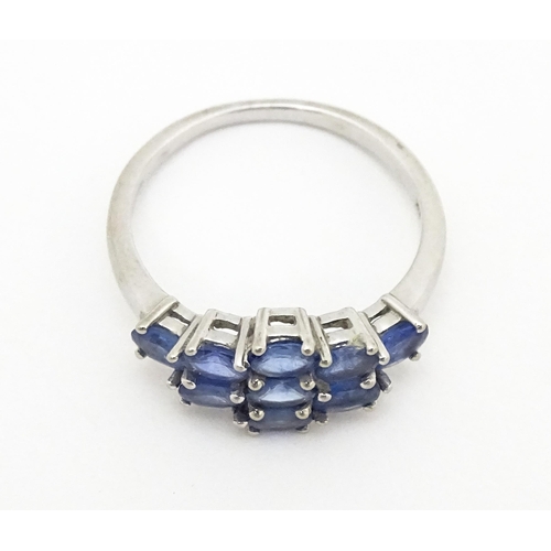 594 - A 9ct white gold ring set with blue stones. Ring size approx. N