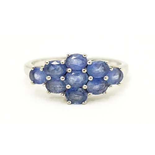 594 - A 9ct white gold ring set with blue stones. Ring size approx. N