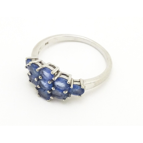 594 - A 9ct white gold ring set with blue stones. Ring size approx. N