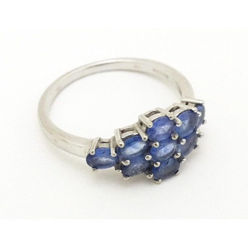 594 - A 9ct white gold ring set with blue stones. Ring size approx. N