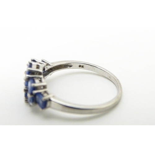 594 - A 9ct white gold ring set with blue stones. Ring size approx. N