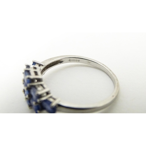 594 - A 9ct white gold ring set with blue stones. Ring size approx. N