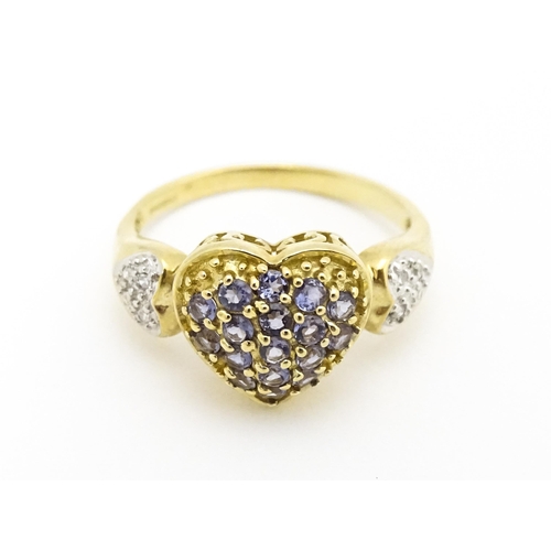 601 - A 9ct gold ring set with lilac coloured iolite and diamonds. Ring size approx. N