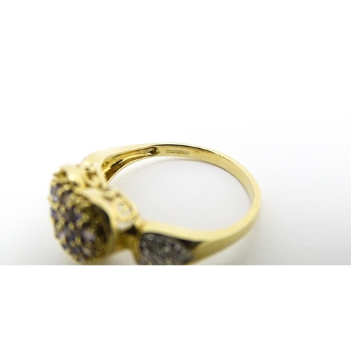 601 - A 9ct gold ring set with lilac coloured iolite and diamonds. Ring size approx. N