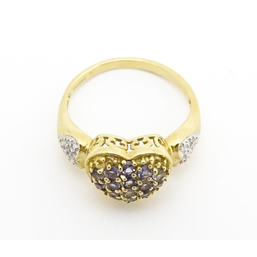 601 - A 9ct gold ring set with lilac coloured iolite and diamonds. Ring size approx. N