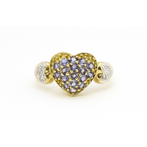 601 - A 9ct gold ring set with lilac coloured iolite and diamonds. Ring size approx. N