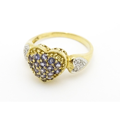 601 - A 9ct gold ring set with lilac coloured iolite and diamonds. Ring size approx. N