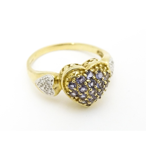 601 - A 9ct gold ring set with lilac coloured iolite and diamonds. Ring size approx. N