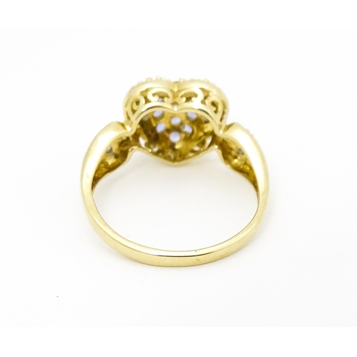 601 - A 9ct gold ring set with lilac coloured iolite and diamonds. Ring size approx. N